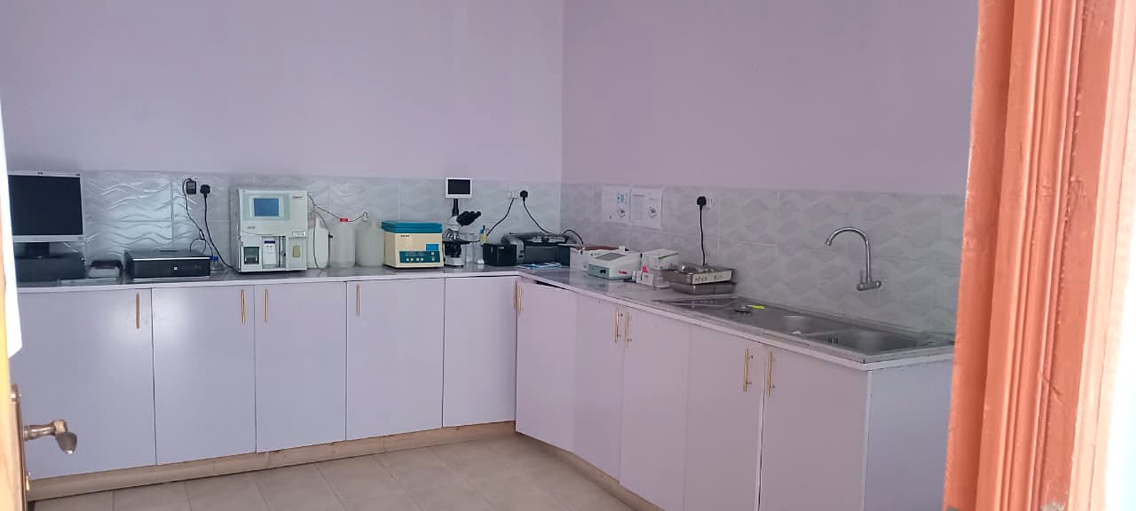 Hospital laboratory bench with haematology analyser and microscope for diagnostic tests